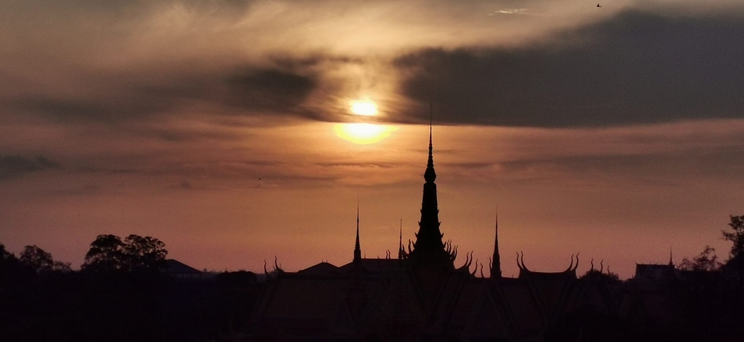 Silhouette of temple spires at sunset.