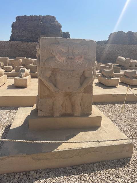 Ancient stone statue among ruins.