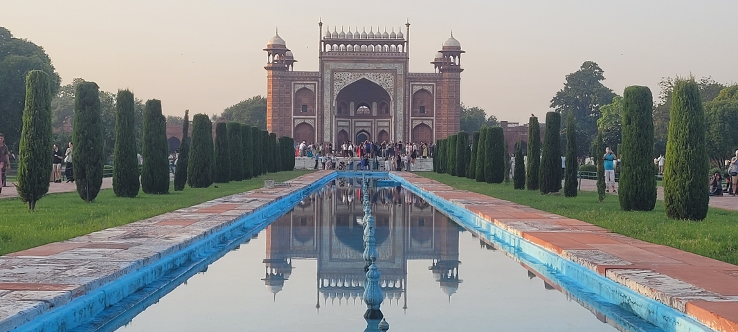 Facade of the Taj Mahal's main entrance with visitors.
