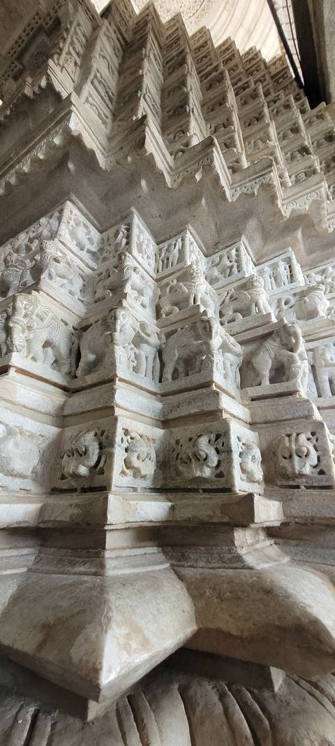 Close-up of intricately carved stone wall with elephant motifs.