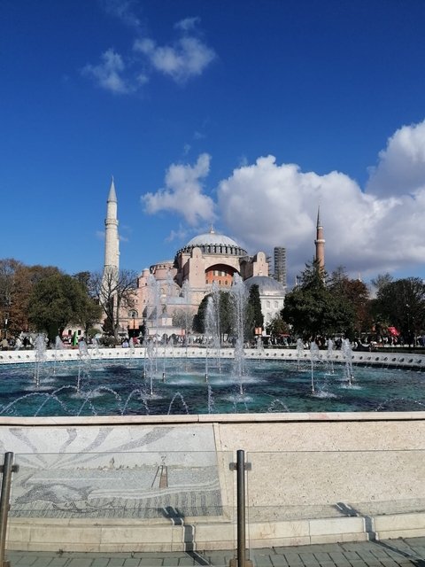 Fountain in front of the magnificent Hagia Sophia under a clear sky.