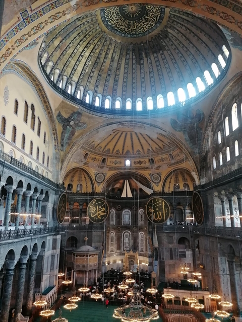 Interior of Hagia Sophia with intricate decorations and Islamic inscriptions.