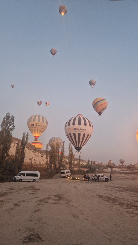 Colorful hot air balloons floating over the unique landscape of Cappadocia.