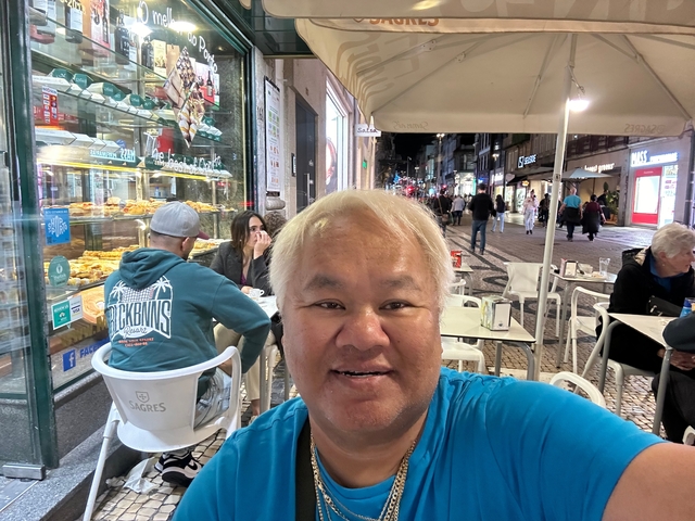 Street scene with cafes and people.