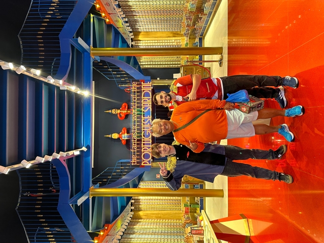 Group of people inside a colorful building.