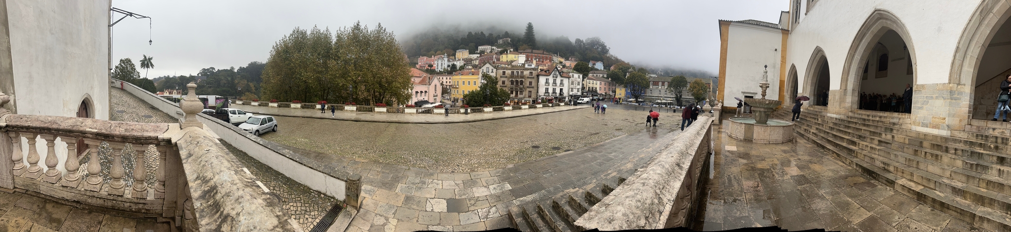 Foggy view of a town with colorful houses.