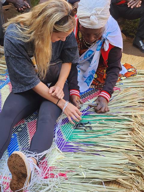 People weaving traditional crafts from natural materials.