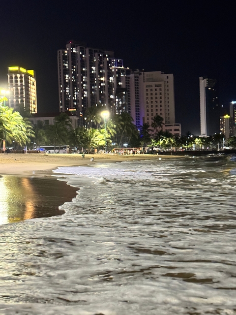 Night beach scene with city lights in the background
