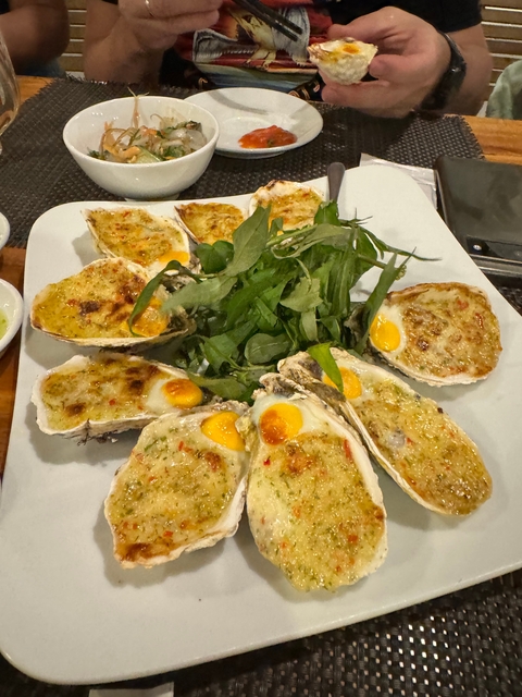 Oysters with herbs and garnishes on a plate