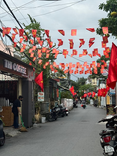 Street scene with red flags in a Vietnamese city