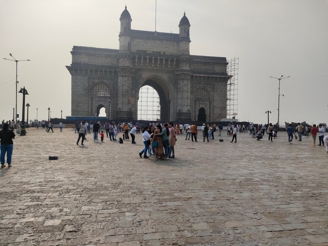The Gateway of India with people around it.