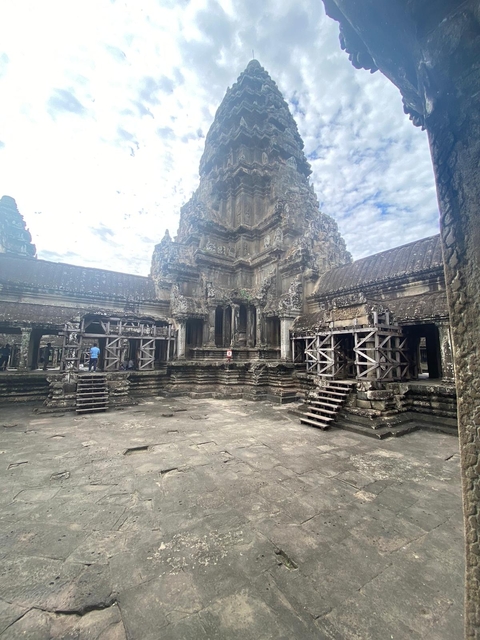 Ancient temple ruins with intricate stone carvings, possibly part of Angkor Wat.