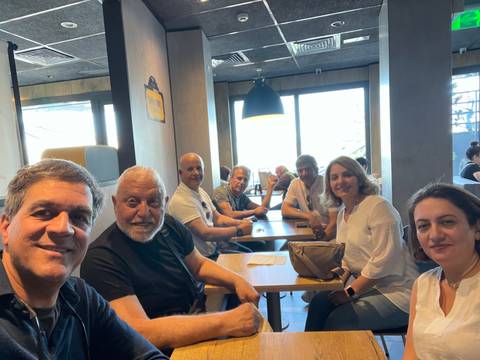 Group of people sitting around a table indoors.