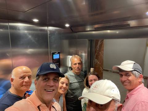 Group of people crowded in an elevator.