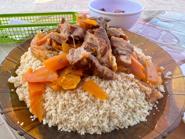 Plate of couscous with meat and vegetables.