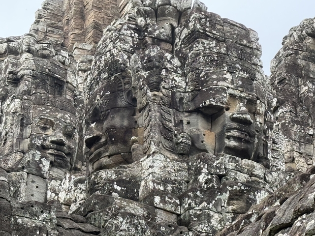 Close-up of ancient stone faces carved into a temple.