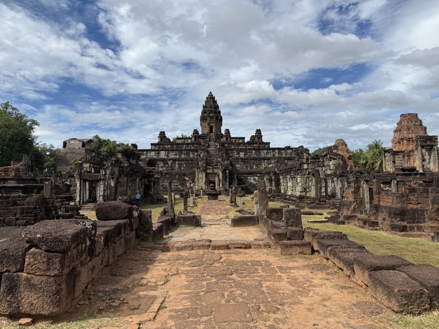Ruins of an ancient temple complex under a blue sky.
