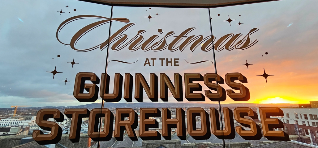 Christmas theme signage at Guinness Storehouse with sunset view.