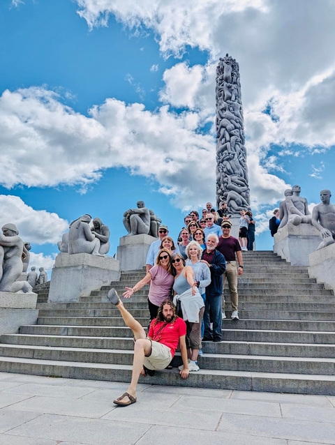 Group in front of the Monolith sculpture in a park.