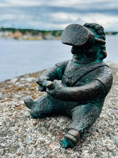 Bronze statue by the water.