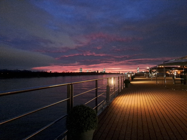 Sunset view from a deck overlooking a river.