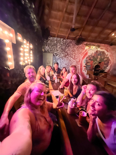 Group of people enjoying drinks indoors.