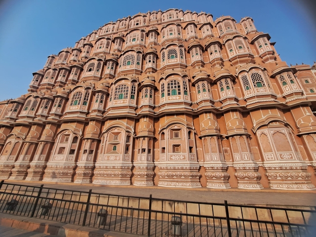 Facade of a historic palace with numerous windows and intricate designs.