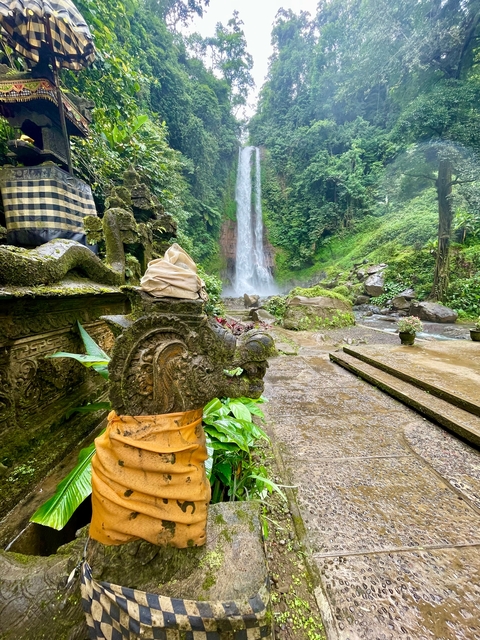 Ornate waterfall temple with intricate carvings.