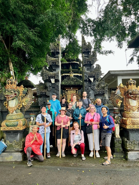 Group posing by a traditional Balinese gate.