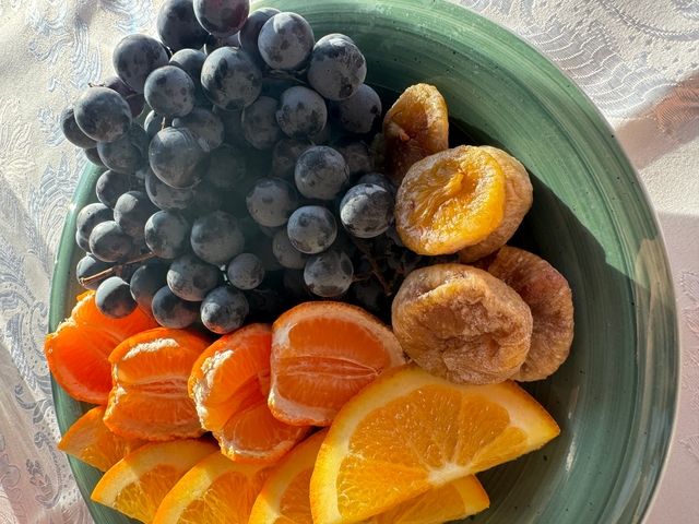 Plate with assorted fresh fruits and nuts.