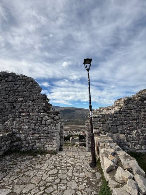 Broken stone wall with view of the valley beyond.
