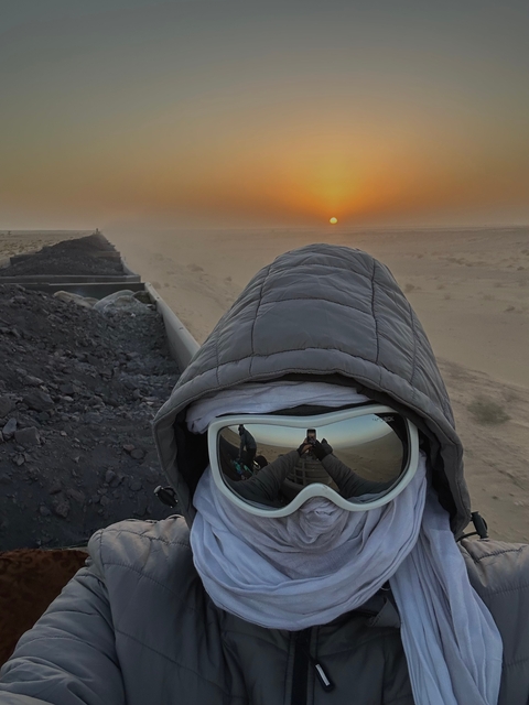 Traveler wearing goggles taking a selfie on a train
