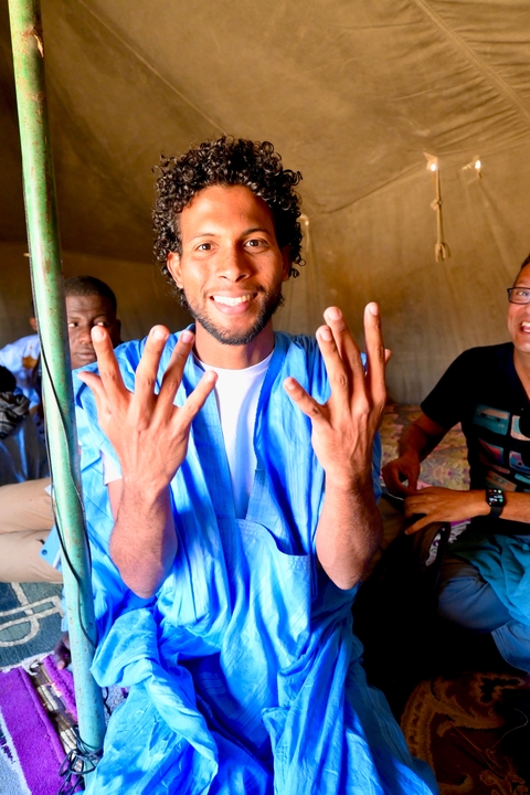 Person in traditional attire showing their hands