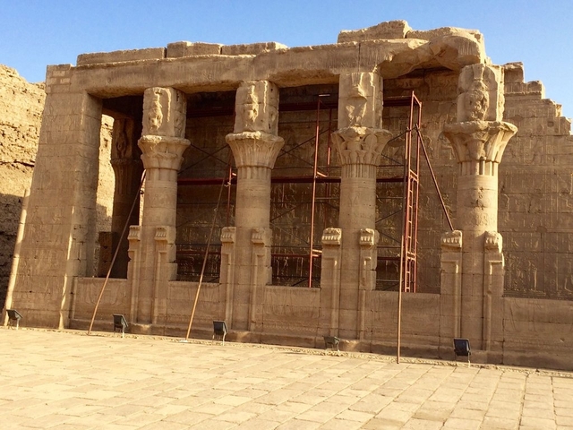 Columns of an Egyptian temple with scaffolding.