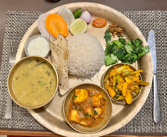 Traditional Nepali meal with rice, lentils, and vegetables.
