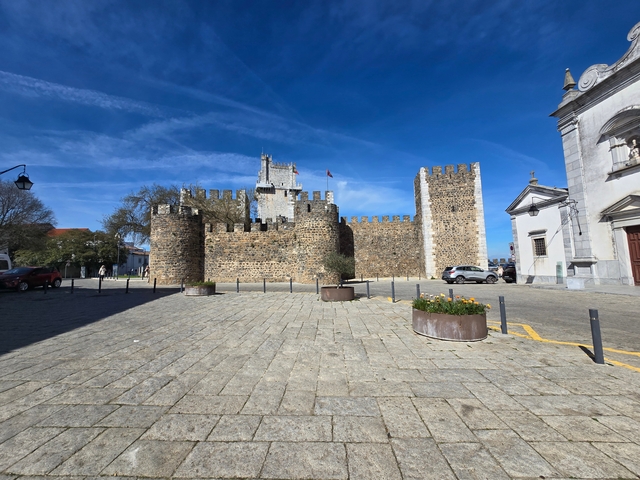 Historic stone castle with clear sky in background.