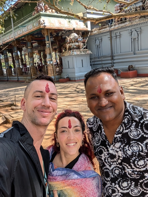 Selfie of three people with traditional forehead marks.