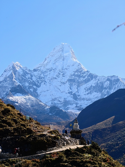 A majestic snow-capped mountain with clear blue sky.