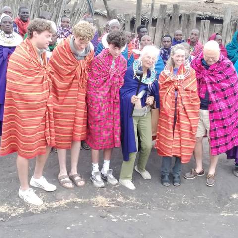 A group of people wearing traditional garments, posing together.