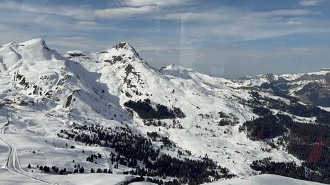 Stunning snow-capped mountain range with forests.