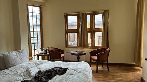 Cozy room interior with wooden furniture and windows.