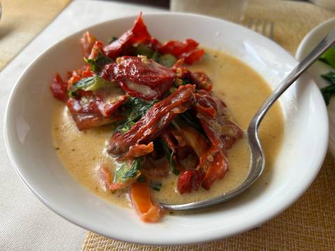 Bowl of traditional Bhutanese dish with dried red chilies and cheese.
