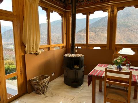Cozy dining area with a stove and view of mountains.