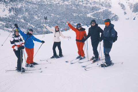Group of skiers posing on snowy slopes.