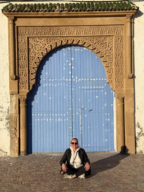 Blue painted decorative door with intricate carvings.