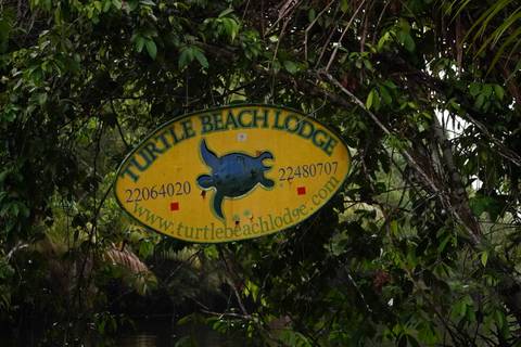 Sign for Turtle Beach Lodge with contact information.