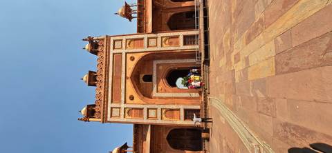 Fatehpur Sikri entrance with tourists gathered.