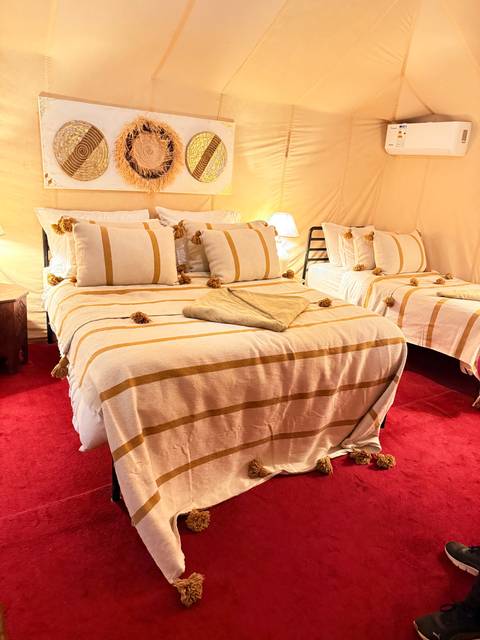 Stylish and comfortable desert tent interior with beds.