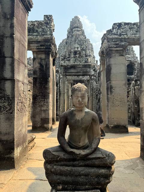 Ancient stone statues in a temple setting.
