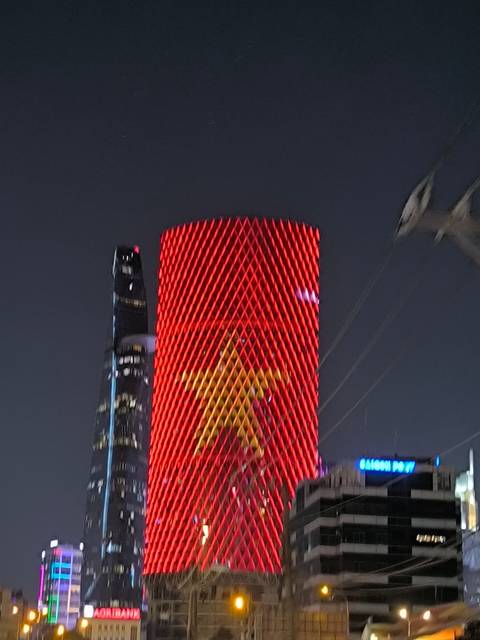 Blurry image of a building with red lighting and a star design.